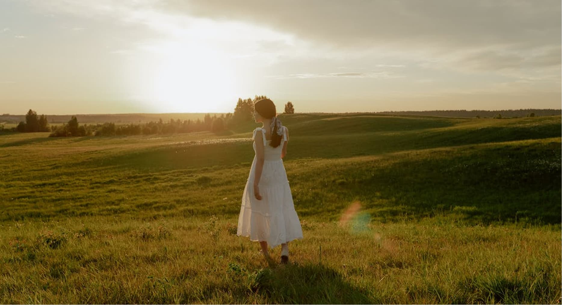 A girl walks across a field