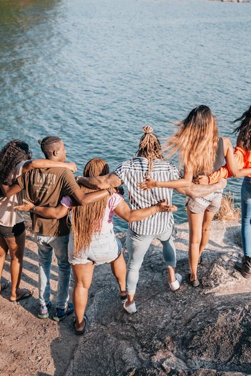 People looking at the water from a cliff