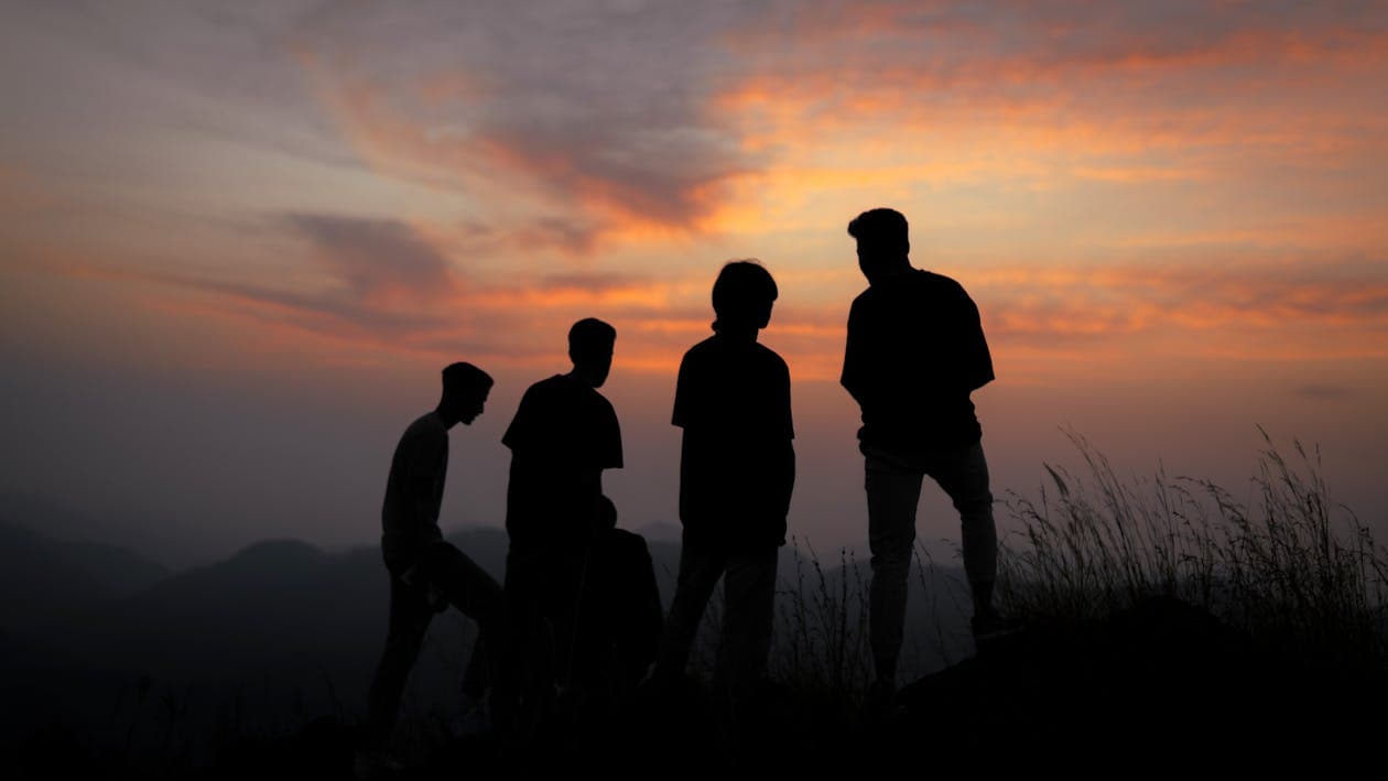 Silhouettes of people against the sunset