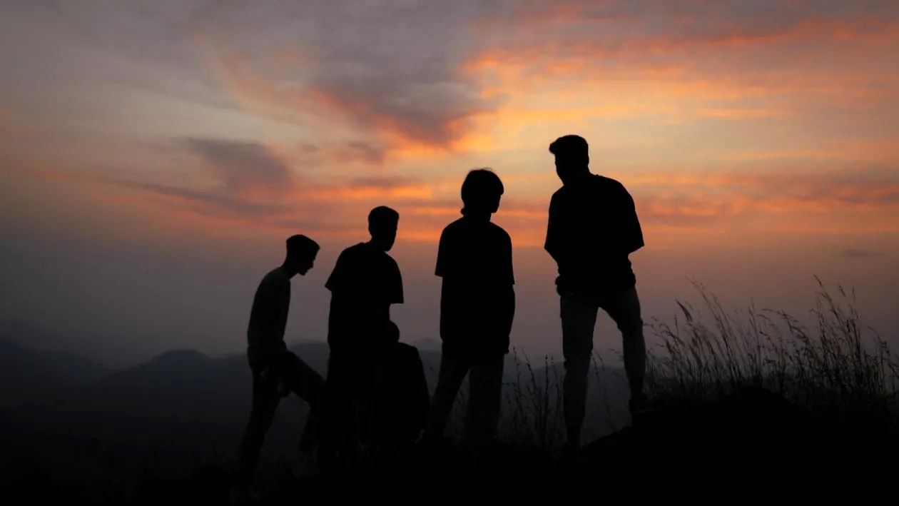 Silhouettes of people against the sunset